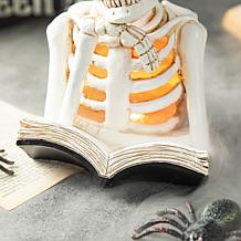 Glitzhome 10.25in. H Halloween Lighted Resin Skull Book Table Decor