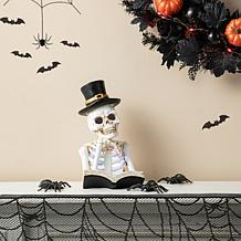 Glitzhome 10.25in. H Halloween Lighted Resin Skull Book Table Decor